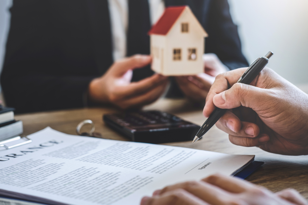 Estate agent giving house and keys to client after signing agree